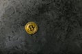 Bitcoin on dark marble. place for an inscription. gold coin bitcoin against the background of a dark stone