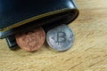 Bitcoin digital currency instead real money, bit-coin with leather wallet or purse on wooden working table, virtual Royalty Free Stock Photo