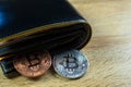 Bitcoin digital currency instead real money, bit-coin with leather wallet or purse on wooden working table, virtual Royalty Free Stock Photo