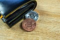 Bitcoin digital currency instead real money, bit-coin with leather wallet or purse on wooden working table, virtual Royalty Free Stock Photo