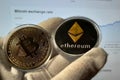 Bitcoin and Ethereum coins on hand in white gloves. Silver gold metal. Cryptocurrency symbols