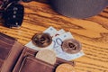 Bitcoin and Ethereum coins on a leather wallet with car keys on an old wooden tabletop. Flat lay photo.