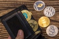 Bitcoin and ethereum lie in black wallet in mans hand closeup Royalty Free Stock Photo