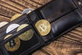 Bitcoin and ethereum lie in black wallet on wooden background Royalty Free Stock Photo