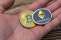 Bitcoin and ethereum lie on mans hand closeup Royalty Free Stock Photo