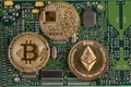 Bitcoin and Ethereum on the printed circuit board.Concept of cry