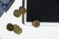 Bitcoin and ethereum symbol on gold coins. Lying on tablet with mockup next to computer graphic card.