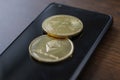 A bitcoin and etherium token on a cell phone Royalty Free Stock Photo