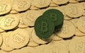 Bitcoin goes green- single green BTC lying against a stack of green coins on a heap of golden coins