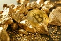 Bitcoin and gold nuggets on table Royalty Free Stock Photo