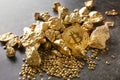 Bitcoin and gold nuggets on table