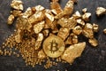 Bitcoin and gold nuggets on table Royalty Free Stock Photo