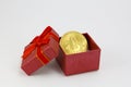 Bitcoin golden coin in a red gift box