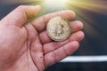 Bitcoin golden token coin in a caucasian male's hand