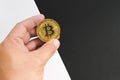 Bitcoin halving concept in cryptocurrency. Hand holding coin in black and white background. Royalty Free Stock Photo