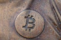 Bitcoin icon on a bronze statue