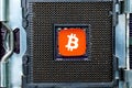 Bitcoin icon on CPU Socket close-up, cryptocurrency and technology concept Royalty Free Stock Photo