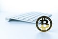 Bitcoin icon. Gold Crypto currency BTC Bitcoin with keyboard on white background. Golden Bit Coin virtual cryptocurrency Royalty Free Stock Photo