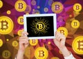Bitcoin icons and hands holding tablet Royalty Free Stock Photo