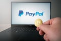 Bitcoin infront of paypal logo on computer laptop