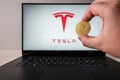 Bitcoin infront of tesla logo on computer laptop. To simulate the future of crypto currency, investment and futureistic