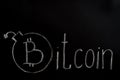 Bitcoin inscription with white chalk on a black board