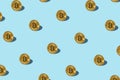 Bitcoin izometric pattern on bright light blue background.