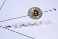 Bitcoin lies on the diagram next to a thermometer with a high te