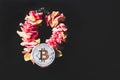 Bitcoin lies on a wreath of flowers, the concept of cryptocurrency prosperity