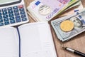 Bitcoin, litecoin, dollar, euro, pen, notepad, calculator on desk Royalty Free Stock Photo