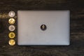 Bitcoin litecoin and ethereum lie on abstract background with silver laptop view from top