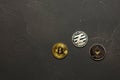 Bitcoin, litecoin and ethereum lie on dark abstract background