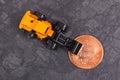 Bitcoin and miniature excavator, symbol of electronic virtual money and mining cryptocurrency Royalty Free Stock Photo