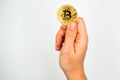 Bitcoin: The new virtual money / Close Up shot of Hand holdling one golden Bitcoin: Business, Money and Technology Concept Royalty Free Stock Photo