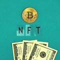 Bitcoin, NFT non fungible token and dollar bills on a office table, new money concept photo, top view