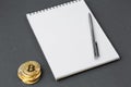 Bitcoin on a notebook, coin bitcoin on a table Royalty Free Stock Photo