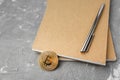 Bitcoin on a notebook, coin bitcoin on a table Royalty Free Stock Photo