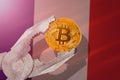 Bitcoin regulation in France; bitcoin btc coin being squeezed in vice on France flag background Royalty Free Stock Photo