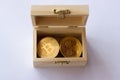 Bitcoin and ripple cryptocurrency in a wooden box