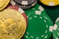 Bitcoin on scattered casino chips on green table