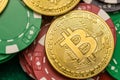 Bitcoin on scattered casino chips on green table