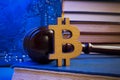 Bitcoin sign and gavel on a book. Cryptocurrency law.