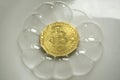 Bitcoin in a soap bubble on purple background with sun light