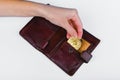 Bitcoin theft concept. A hand steals bitcoin from a wallet. Place for writing Royalty Free Stock Photo