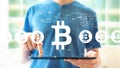 Bitcoin theme with man using a tablet Royalty Free Stock Photo