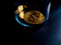 Bitcoin token rests against black background Royalty Free Stock Photo