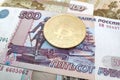 Bitcoin on top of a stack of Russian Ruble banknotes