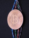 Bitcoin and twisted cables Royalty Free Stock Photo
