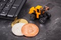 Bitcoins as symbol of electronic virtual money, miniature excavator and computer keyboard, mining cryptocurrency concept Royalty Free Stock Photo