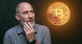 Bitcoins - Bitcoin in hand of a casual businessman wondering what the future is
